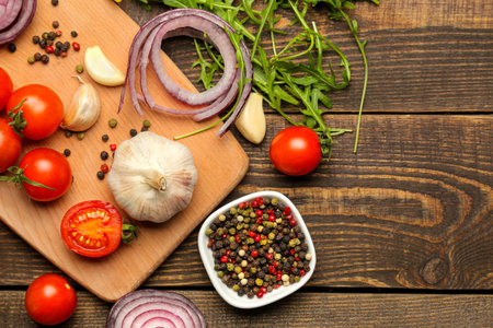 cooking background, home cooking concept. Ripe vegetables, herbs and spices on a wooden background, top view, copy space.の写真素材