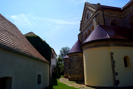 Church, house and grass - Hosin, South Bohemiaの写真素材