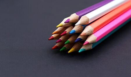 Sharp colored pencils on a black backgroundの写真素材