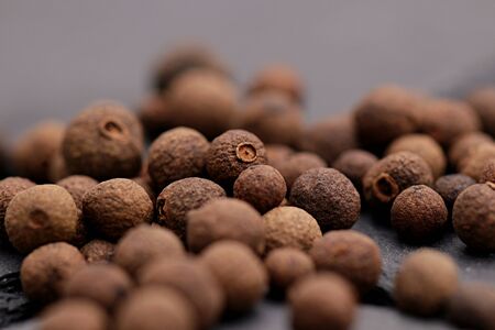 Allspice balls lying on a dark tableの写真素材