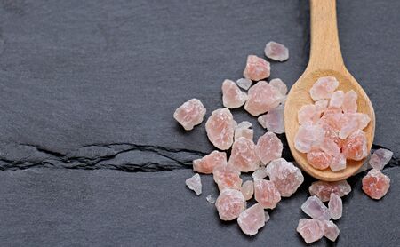Pieces of Himalayan salt on a spoonの写真素材