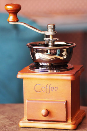 An old coffee grinder is on the table