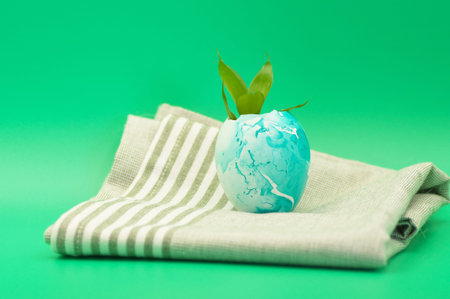 A sprout sprouting from an Easter egg