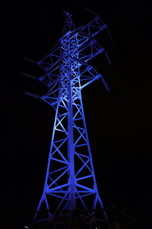Blue light illumination of the power line supportの写真素材