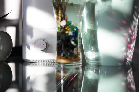 The handle of the humidifier on the table among the plants in the houseの写真素材