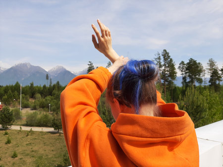 Girl with blue hair against the background of the Eastern Sayan Mountainsの写真素材