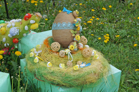 Decorative Easter eggs made of ribbons, threads and fabric at the Easter fair on a spring day