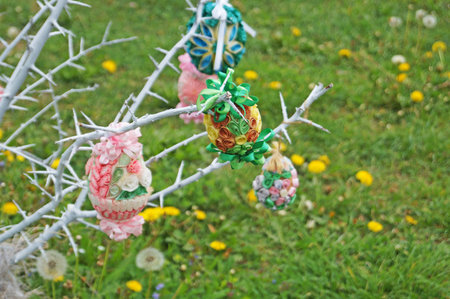 Decorative Easter eggs made of ribbons, threads and fabric at the Easter fair on a spring day
