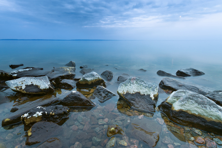 stones in the water at slow shutter speeds, overcast evening timeの写真素材