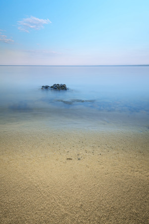 stones in the water at slow shutter speeds, overcast evening timeの写真素材
