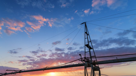 evening field irrigation / sprinkler system for the fields on the background of a sunset bright sky evening landscapeの写真素材