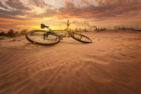 bicycle in the desert / yellow hot sunset late summerの写真素材