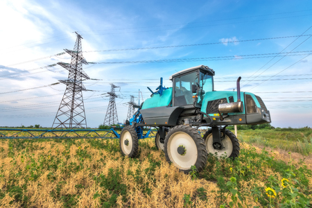 tractor sprayer close-up / tractor standing waiting for workの写真素材