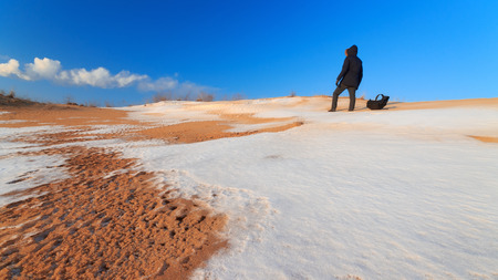 man standing on a hill / winter walk snow-covered hillの写真素材