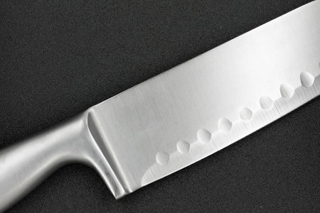 knife blade on dark grey background / metal kitchen knife knife blade