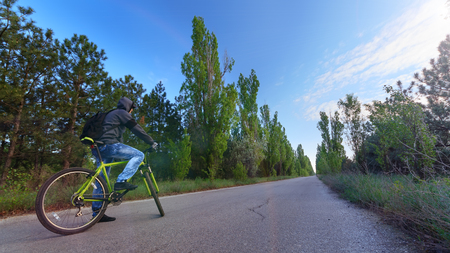 cyclist on the road / Cycling on the roads outside the cityの写真素材