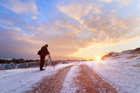 man standing on the trail / winter landscape off-road trackの写真素材
