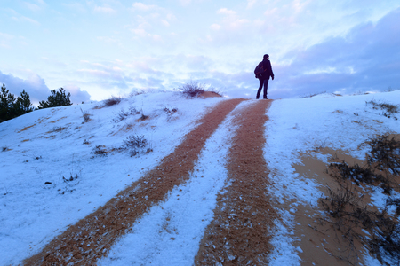 man standing on the trail / winter landscape off-road trackの写真素材