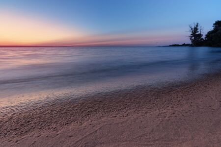 early morning sunrise on a choppy river / wind early spring landscapeの写真素材