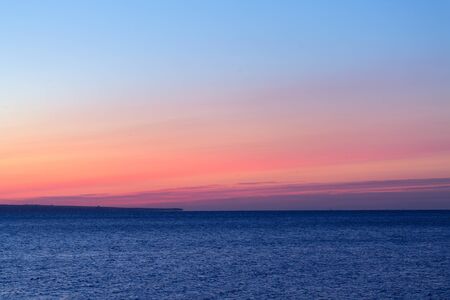 early morning sunrise on a choppy river / wind early spring landscapeの写真素材