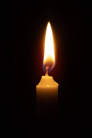 candle on black background / bright burning candle bright glow lightの写真素材