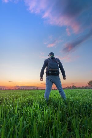 man looks at the sky / bright spring landscapeの写真素材