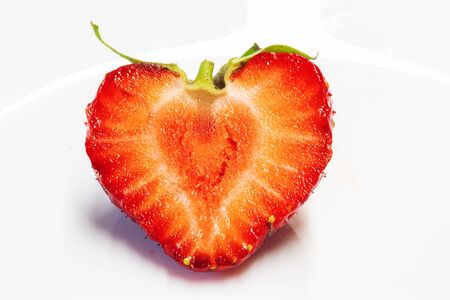 strawberry close-up / on a white plate backgroundの写真素材