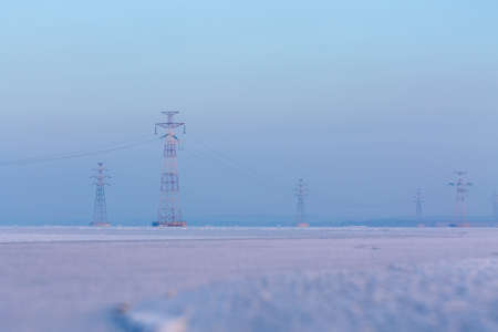 winter landscape, frozen river power lineの写真素材