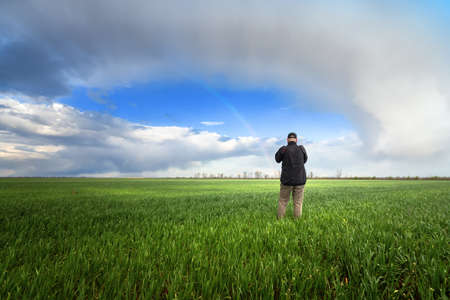 field of young wheat / man on the field agricultureの写真素材