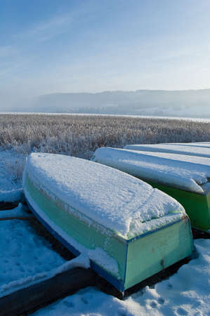 boats in wood covered by snowの写真素材