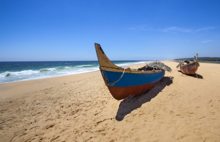 Boats on the beach at the background of the oceanの写真素材