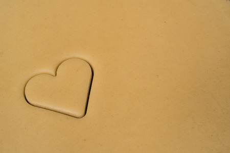 Rolled out pastry with cutted heart for cookiesの写真素材