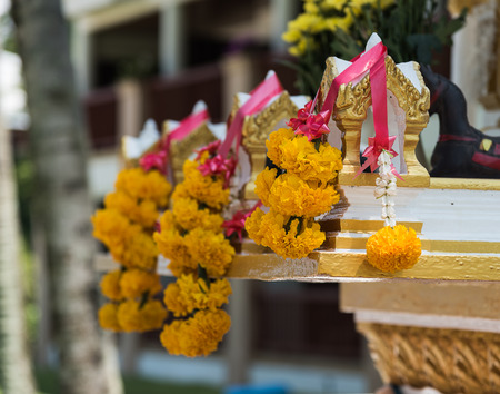 Flowers on street spirit house in Thailandの写真素材