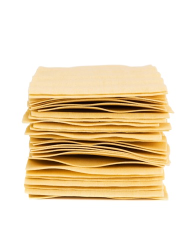 Stack of sheets for lasagna isolated on white with shadowの写真素材