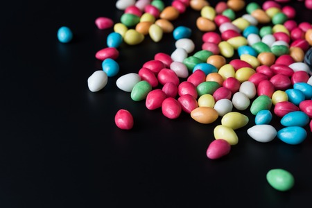 Bonbons on black background, dramatic side lightの写真素材