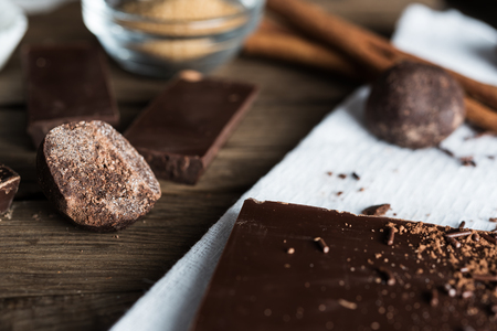 Closeup on cut of cocoa bean and ingredients for dessert preparation aroundの写真素材