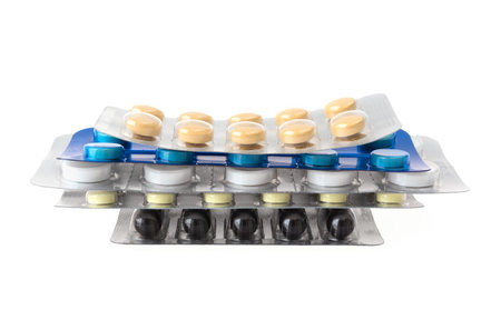 Different blisters with pills on white background