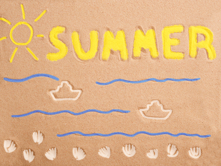Sand with drawing - sun, waves, boats, seashells and word SUMMER, coloredの写真素材