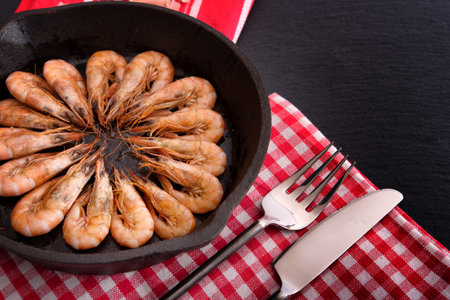 Top view on frying pan with cooked shrimps