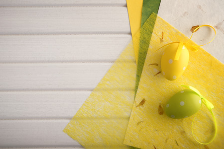 Decorative paper and easter eggs on wooden tableの写真素材