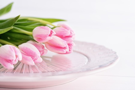 Closeup of pink tulips on pink plateの写真素材