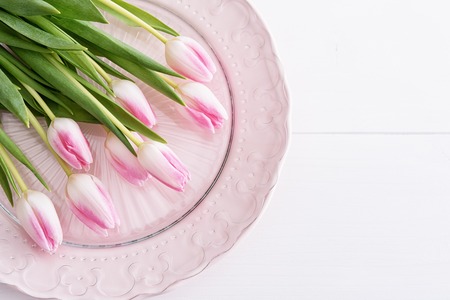 Top view on pink tulips on pink plateの写真素材