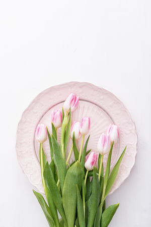Top view on pink tulips on pink plateの写真素材
