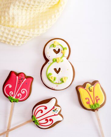 Homemade gingerbread cookies for March 8th in shape of tulips and number 8の写真素材
