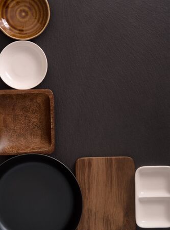 A frame of empty saucers, boards and a frying panの写真素材