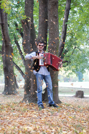 Man playing accoridion in parkの写真素材