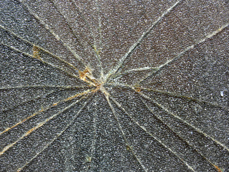 Sunburst pattern on broken safety glass.
