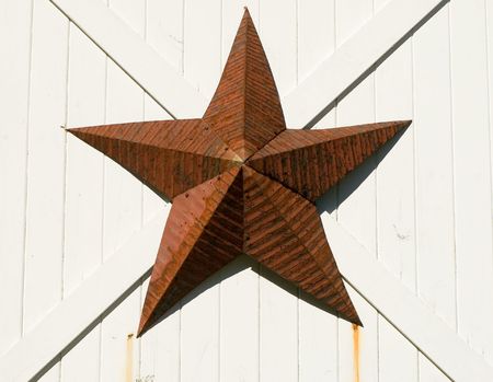Amish decorative red tin star, on a barn door.の写真素材