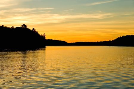 Sunset over a lake in cottage country, Muskoka, Ontario, Canada.の写真素材