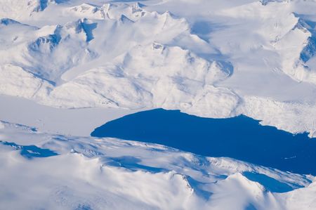 Lakes, snow, ice and mountains - an aerial view of the coast of Greenland.の写真素材